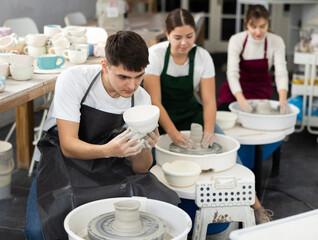 Wall Mural - Young man holding finished pottery made on potter's wheel