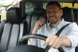 © New Africa - Man talking on phone while driving modern car, view through windshield