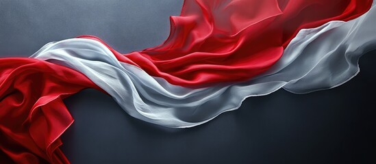 Poster - Silk flag fabric flowing gracefully with vibrant red and white colors against a soft grey backdrop creating a dynamic visual contrast