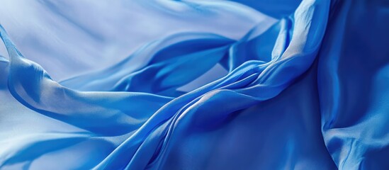 Poster - Flowing blue silk fabric background for elegant design and creative projects in educational or artistic settings.