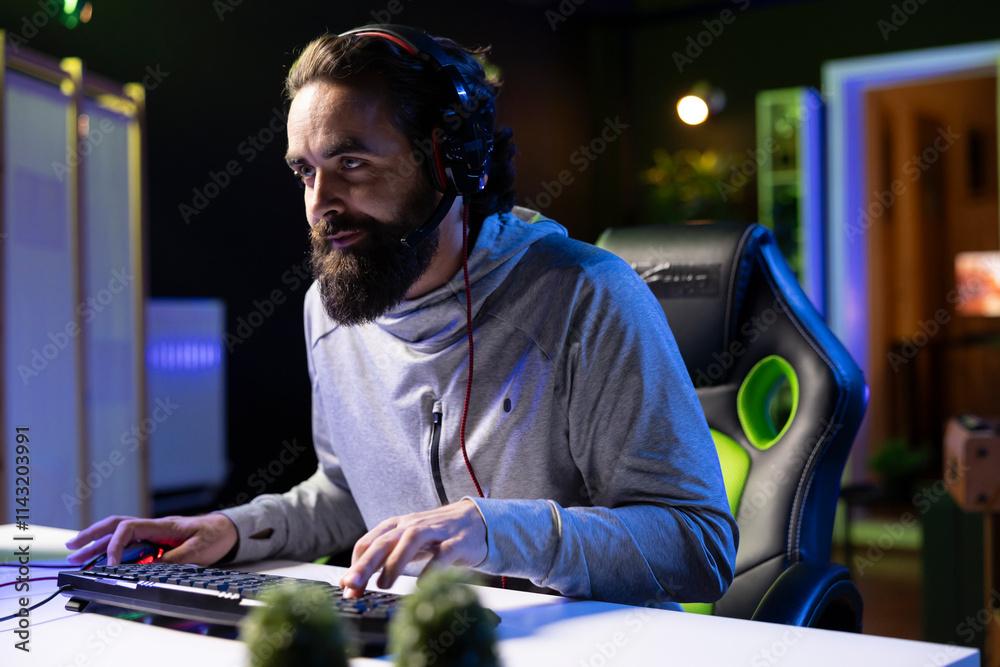 Man powering up computer to play videogames after arriving home in neon ...