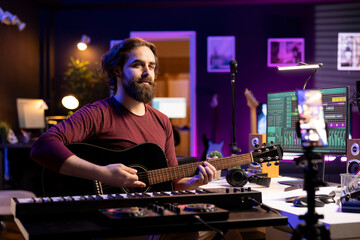 Poster - Skilled artist teaching how to play acoustic guitar on internet, creating online tutorial to give assistance with musical instrument. Musician performer explaining accords and notes on each strings.