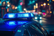 © Zulkifle - Close-up of blue police lights on top of a car at night with a blurred background.