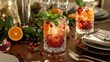 © peppastocker - Refreshing pomegranate cocktails with mint and orange on a festive table setting for winter