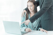 © MrAshi - The female employee is uncomfortable. Look at the hand of your boss or male co-worker as they touch your shoulder and embrace. inappropriate sexual harassment