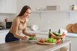 © Pixel-Shot - Young woman making vegetable salad in kitchen. Keto diet concept