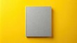 © lapeepon - A minimalist booklet with a yellow background and gray text on the cover, featuring a subtle texture effect , minimalism