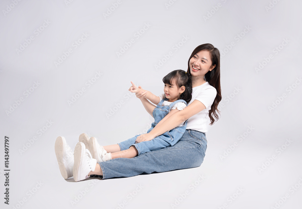 Full Body Image Of Asian Mother And Daughter Posing On White Background 