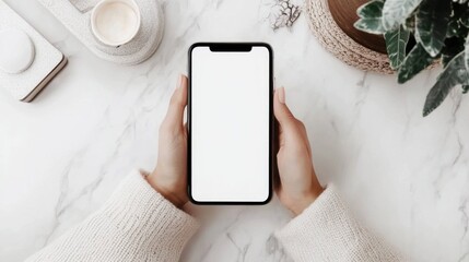 Woman seated, holding a mobile phone with a blank screen.