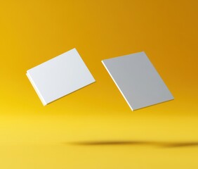 Poster - Two Minimalist White Books Floating Against a Bright Yellow Background, Perfect for Modern Design, Creative Concepts, and Artistic Imagery