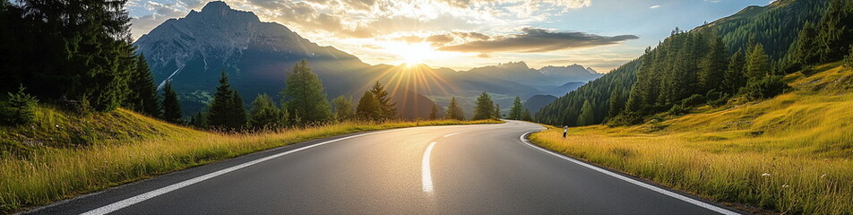 Poster - A beautiful rural landscape with the sunset over an asphalt road winding through green meadows. Sunset panorama.