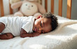 © Юлия Падина - An afro-american baby peacefully sleeping in a cozy crib with a soft blanket and a plush toy in a warm, softly lit nursery