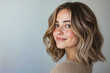 © stanhert - A woman with a shoulder length wavy bob with blonde highlights