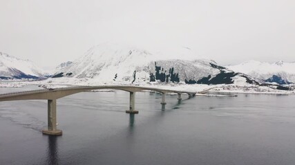 Wall Mural - 4k drone forward video (ultra high definition) of gimsoystraumen bridge. cold winter scene of lofote
