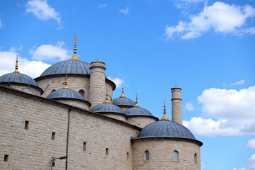 Ottoman-style building with domes against blue sky