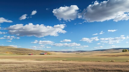 Poster - Expansive rural American farm landscape showcasing vast fields and distant red barns under a bright blue sky with scattered clouds