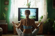 © lashkhidzetim - woman is sitting on the floor in front of a television. She is wearing a blue top and grey pants