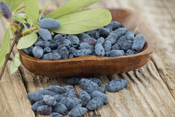 Wall Mural - Honeyberry haskap berries situated on rustic wooden table