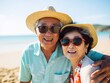 © Human AI - happy asian seniors couple in beach senior man and woman old retired couple relaxing by the Asia sea on sunny day.