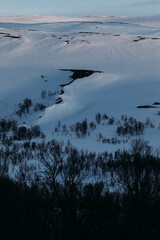 Wall Mural - Serene snow-covered mountain valley at sunset