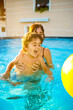 © unai - Mother and son laughing and having fun in swimming pool during summer vacation