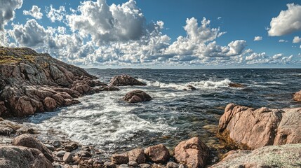 Aufkleber - Rocky shoreline under dynamic clouds and gentle waves in a coastal landscape near the ocean