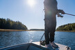 © Johnér - Low section of mid adult woman fishing while standing on boat
