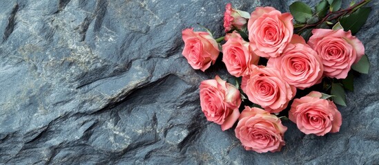 Poster - Elegant pink rose bouquet resting on textured stone background ideal for bridal floral arrangements and wedding decor concepts.