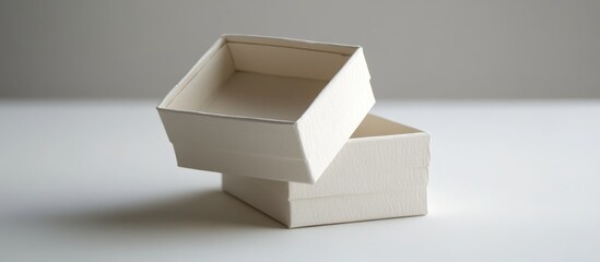Poster - Minimalist stack of empty white cardboard gift boxes on a clean surface ideal for packaging and presentation in various occasions