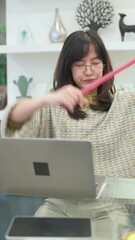 Poster - Vertical video of Focused woman celebrating success while working on laptop in modern home office setting
