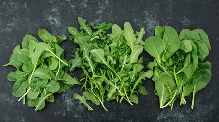 Poster - Fresh arugula and spinach leaves arranged on a dark textured surface showcasing vibrant green colors for healthy eating and cooking concepts.