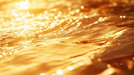 Poster - Golden shimmering bokeh effect on water surface with soft reflections and warm lighting creating a tranquil abstract background.