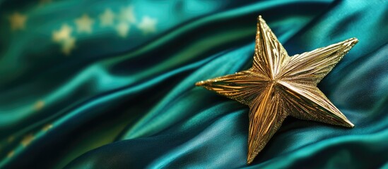Poster - Golden star ornament on a rich green and blue fabric background symbolizing festive elegance and holiday spirit for Christmas celebrations.