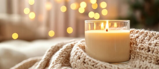 Aufkleber - Cozy handmade natural wax candle with wooden wick illuminated beside a soft knitted blanket creating a warm ambiance for relaxation