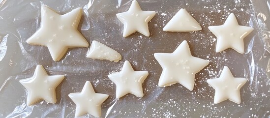 Aufkleber - Homemade star-shaped cookies decorated with icing on waxed paper showcasing various sizes and delightful designs