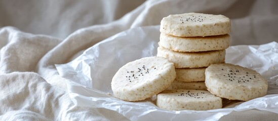 Aufkleber - Oatmeal shortbread cookies stacked on white paper with a soft cloth background perfect for healthy snacking and enjoyment in homemade treats