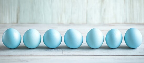 Aufkleber - Blue Easter eggs neatly lined up on a light gray wooden surface with ample space for personalized text or messages for the holiday season.
