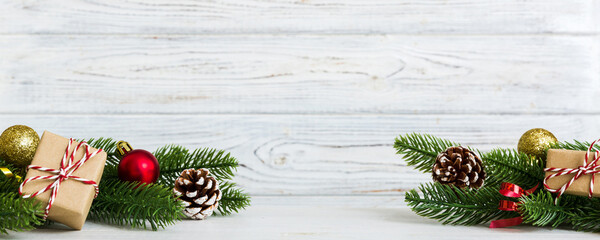 Wall Mural - New Year Christmas mood, gift box, branches of a christmas tree, New Year decorations on a colored background