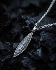 Poster - Diamond pendant necklace on a dark, rocky surface.