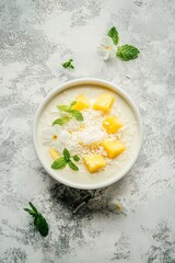 Poster - Mango dessert with coconut and mint on textured backdrop.