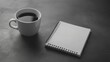 © B & W MeMiN - A minimalist scene featuring a cup of coffee beside an empty notepad on a dark surface, evoking a sense of calm and focus.