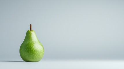 Wall Mural - Single green pear on light gray background.