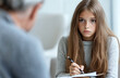 © Olga - A teenage girl writing in a journal during a session, encouraged by the psychologist