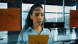 © Summit Art Creations - Young hispanic employee writing on colorful sticky notes. Smart businesswoman sharing marketing idea, brainstorming strategy, business plan. Project manager drawing mind map. Closeup. Manipulator.