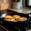 © Thawinrat - Sizzling Action Homemade Pancakes in a Cast Iron Skillet Kitchen Setting Food Cozy Atmosphere
