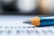 © Odin AI - Close-up view of a sharpened pencil resting on lined paper with faint grid lines in the background during study time