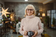 © Miljan Živković - portrait of senior woman stand with mug and enjoy at her coffee