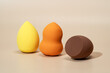 © ADDICTIVE STOCK - Three vibrant cosmetic sponges for flawless makeup application