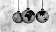 © SusDmi - Three pendant Earth globes arranged in a row against a blurred gray background. Clear continent outlines and reflective surface, silhouette, with white tones