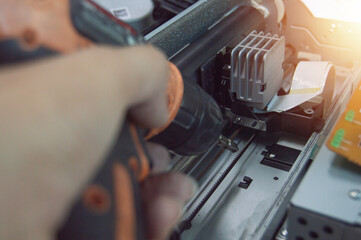 Poster - side view of technician inspecting and repairing printer.